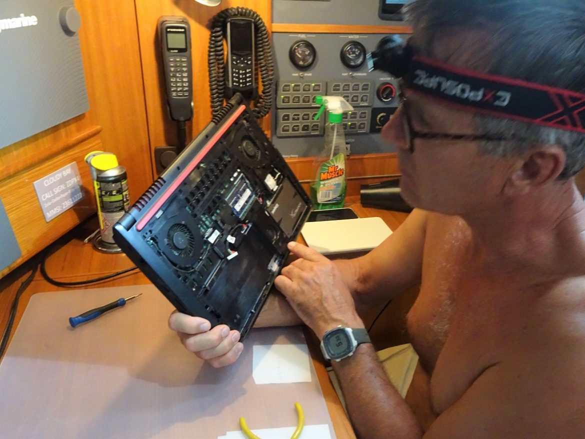 Glen takes the laptop apart to dry it from the tea