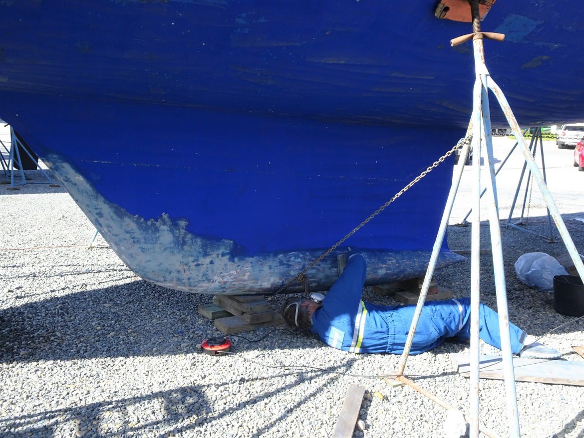 Glen sands the antifouling on the keel