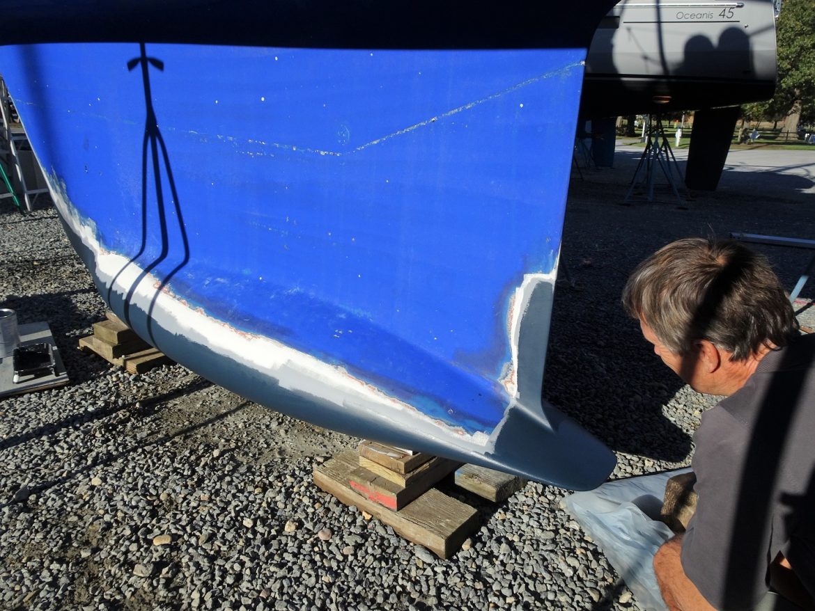 Glen admires his painting job on the keel Glen admires his painting job on the keel