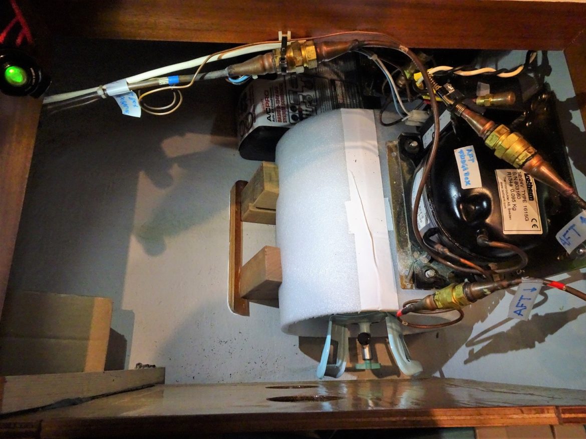 Wood blocks cut and fridge coolant gas bottle secured under the compressor Wood blocks cut and fridge coolant gas bottle secured under the compressor