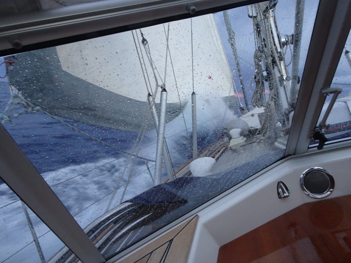 Sailing hard on the wind, the waves are breaking on the bow all the way up to the genoa.