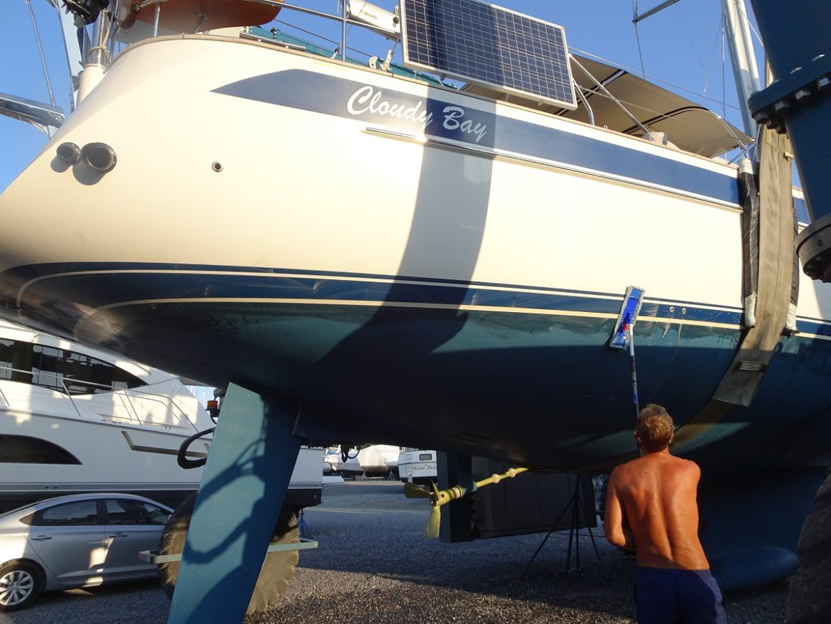 Glen washes the waterline of s/v Cloudy Bay