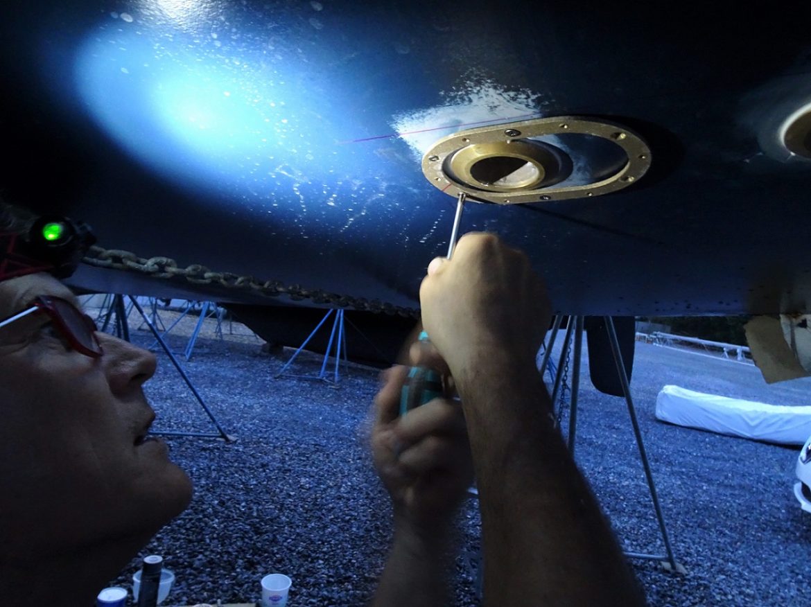 Glen installing the scoop strainers- s/v Cloudy Bay