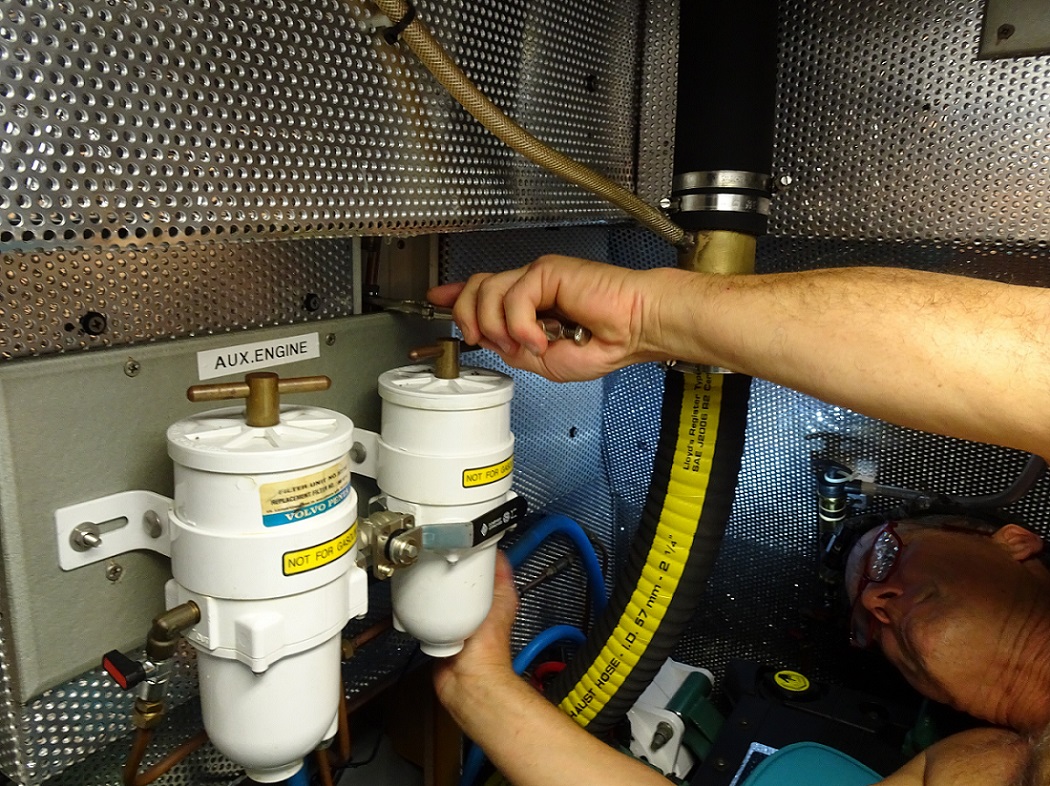 Glen struggles to reach behind engine wall to install the faucet – s/v Cloudy Bay Glen struggles to reach behind engine wall to install the faucet - s/v Cloudy Bay