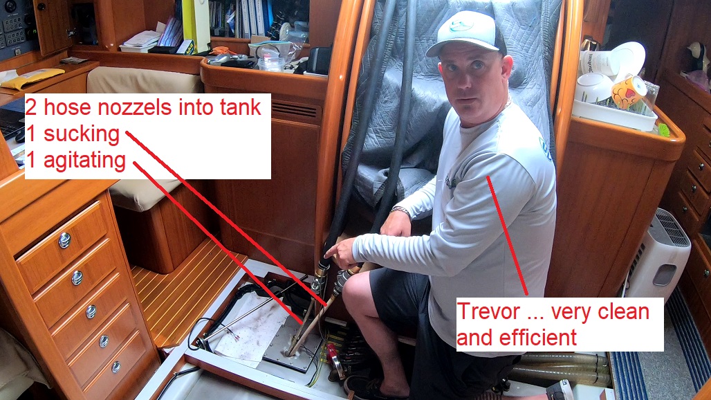 polish diesel tanks: Trevor operates 2 hose nozzles into tanks